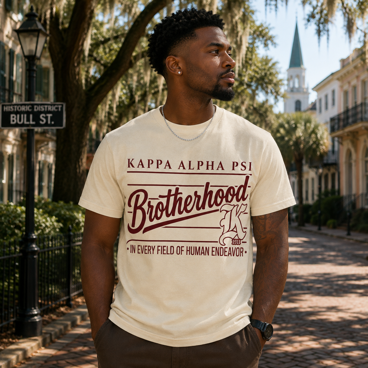 Model wearing the Kappa Alpha Psi Brotherhood cream T-shirt with refined maroon fraternity graphic