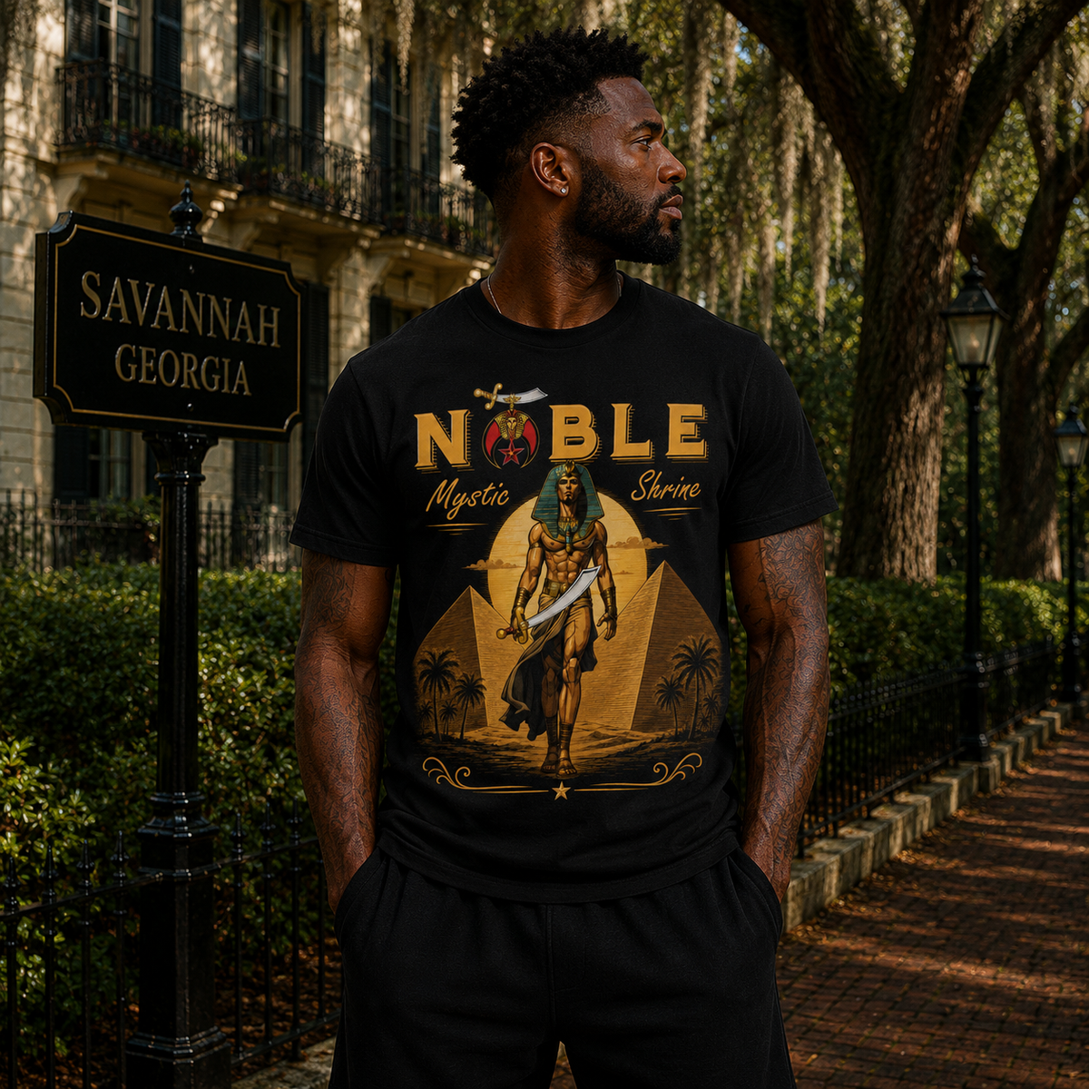 Model wearing the Shriners Noble Mystic black T-shirt with Egyptian-inspired desert artwork