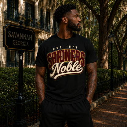 Model wearing the Shriners Noble black T-shirt with maroon, cream, and gold collegiate graphic