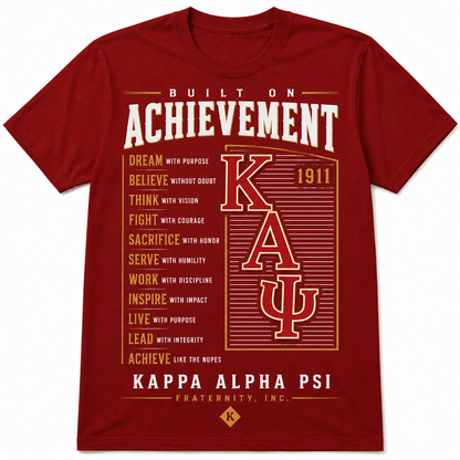 Red Kappa Alpha Psi Built on Achievement T-shirt with motivational statements, large ΚΑΨ lettering, and 1911 detail
