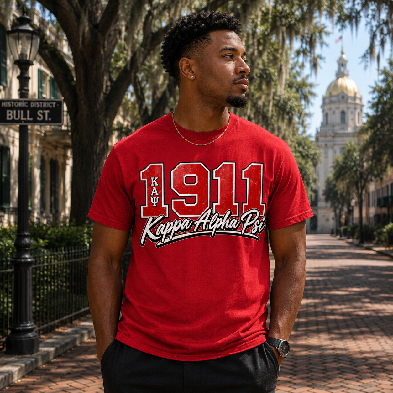 Model wearing the Kappa Alpha Psi 1911 red T-shirt with vintage varsity numbers and script graphic