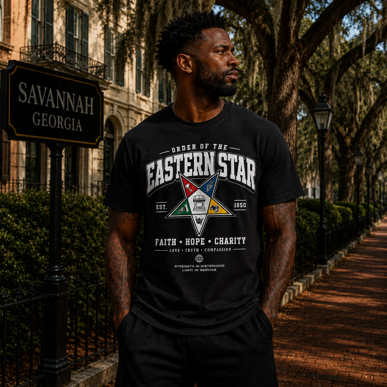 Black man wearing the Order of the Eastern Star Strength in Sisterhood black T-shirt outdoors in Savannah, Georgia