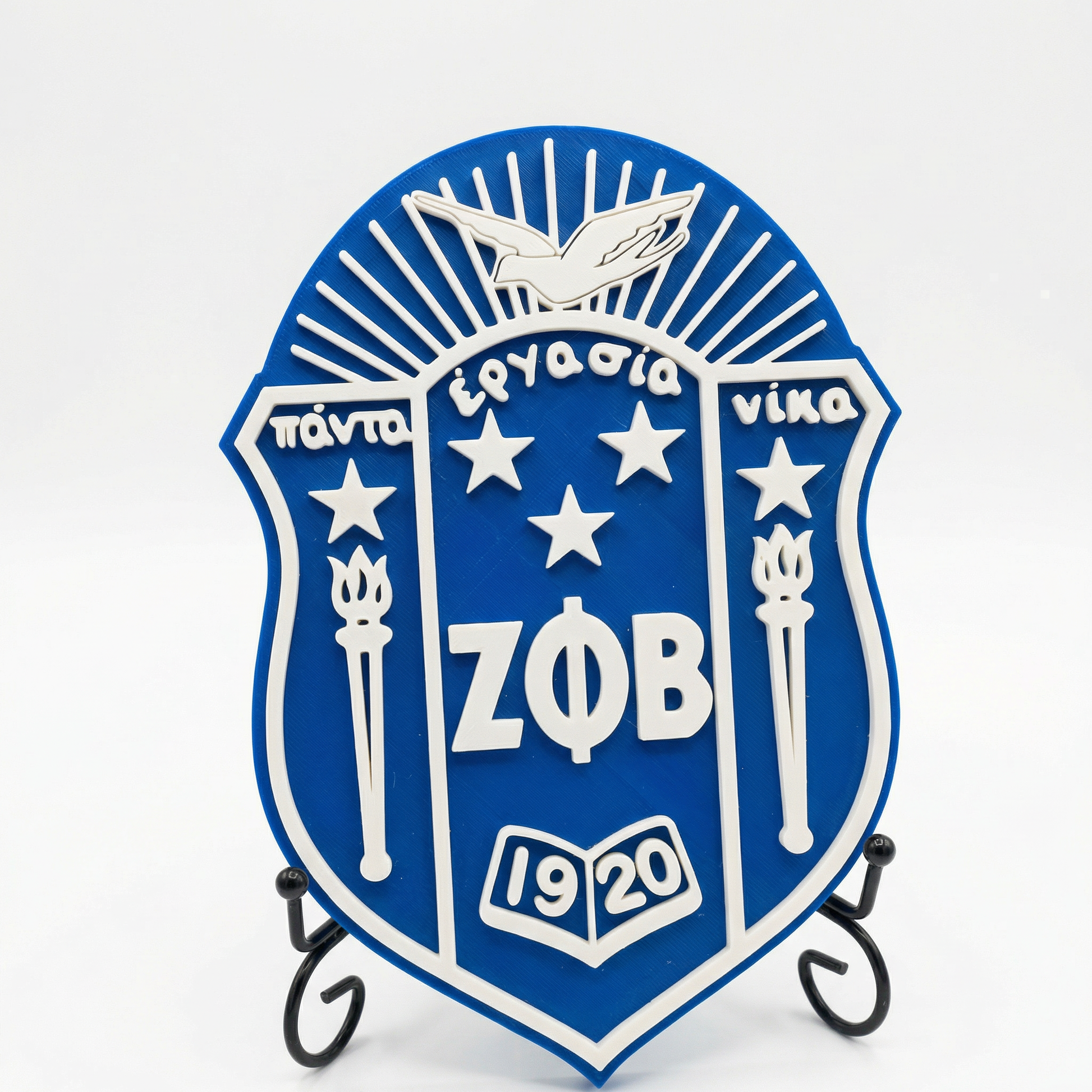 Blue and white emblem with 'ZFB' and stars on a stand against a white background