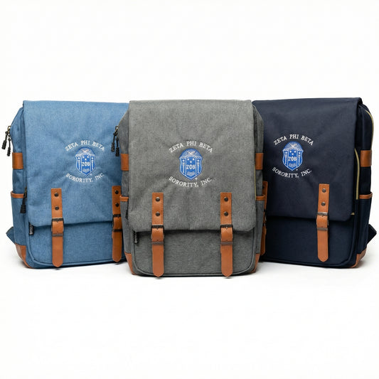 Three bags in blue, gray, and navy with brown straps on a white background