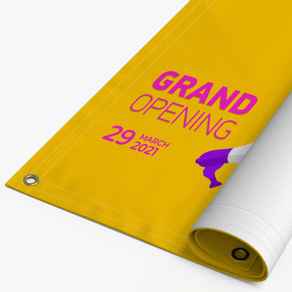 A rolled-up yellow banner with the text 'GRAND OPENING' and a date, indicating a business opening celebration.