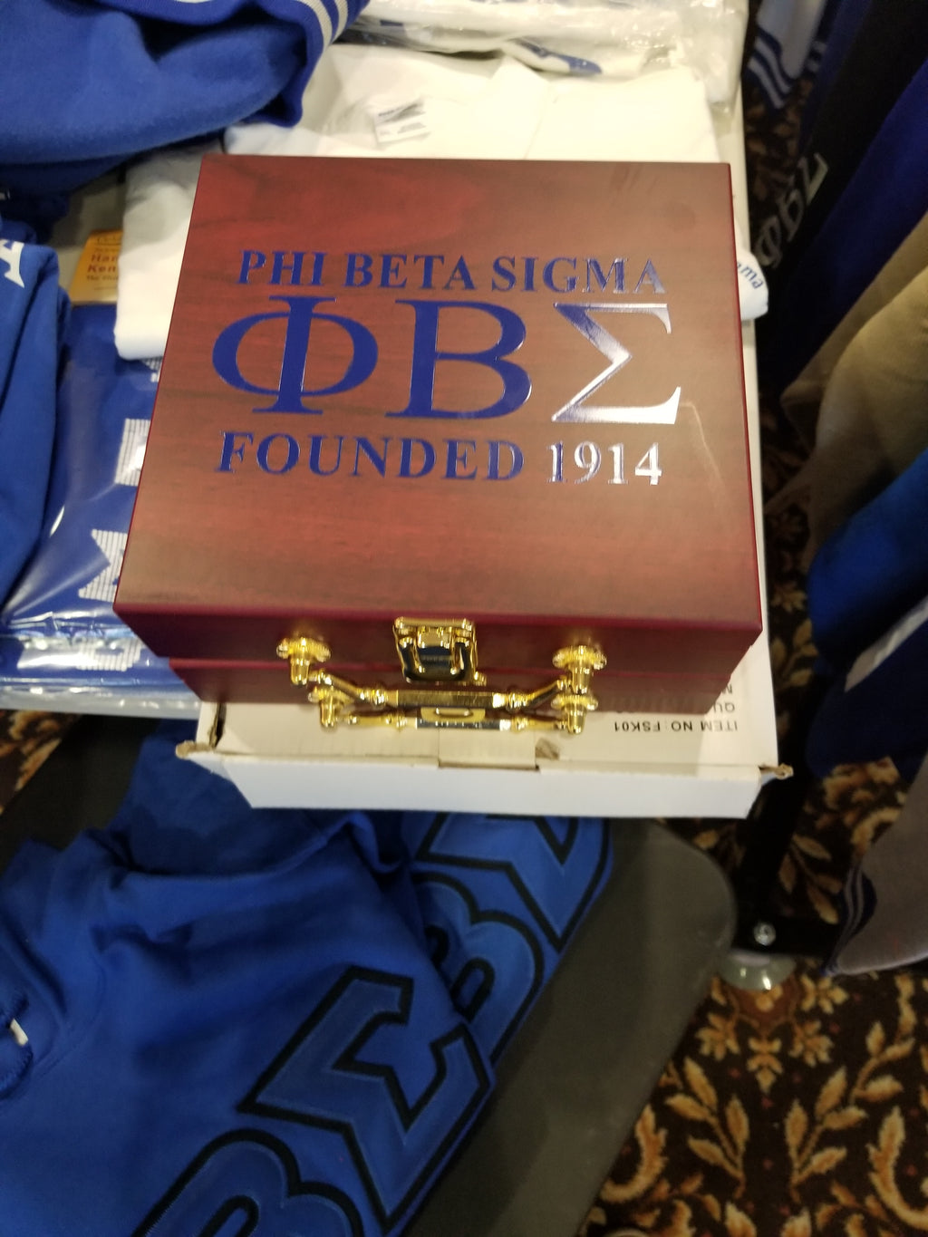 A Phi Beta Sigma poker set displayed on a table with packaging that includes the fraternity's logo and the founding year.